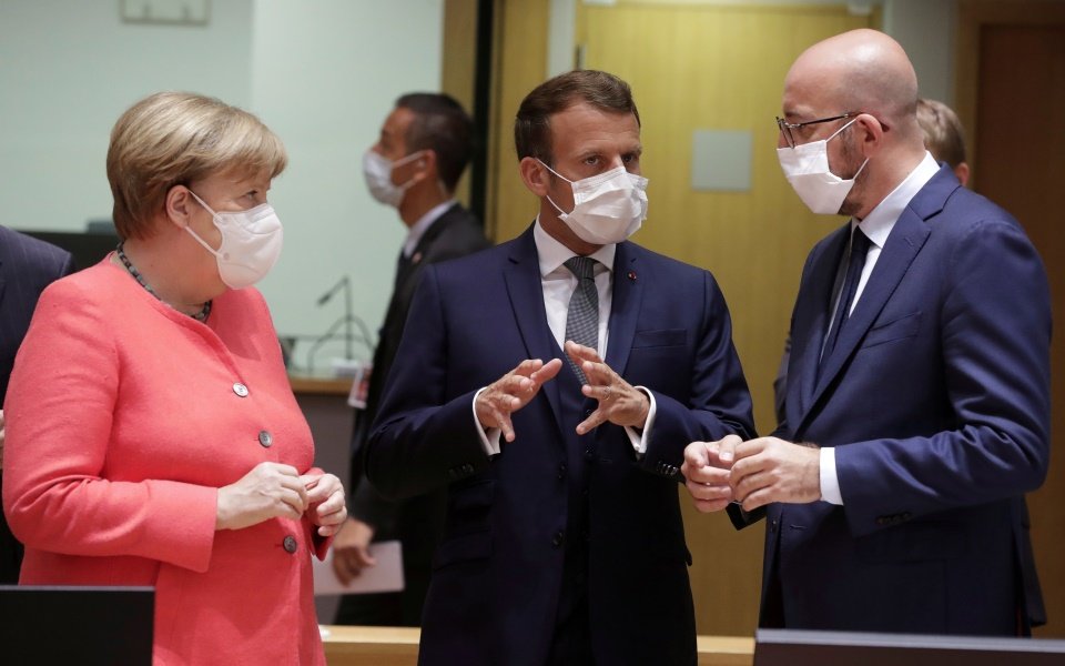 Germany's Chancellor Angela Merkel, French President Emmanuel Macron and European Council President Charles Michel talk at the start of the first face-to-face EU summit since the coronavirus disease (COVID-19) outbreak, in Brussels, Belgium July 17, 2020. Stephanie Lecocq/Pool via REUTERS     TPX IMAGES OF THE DAY